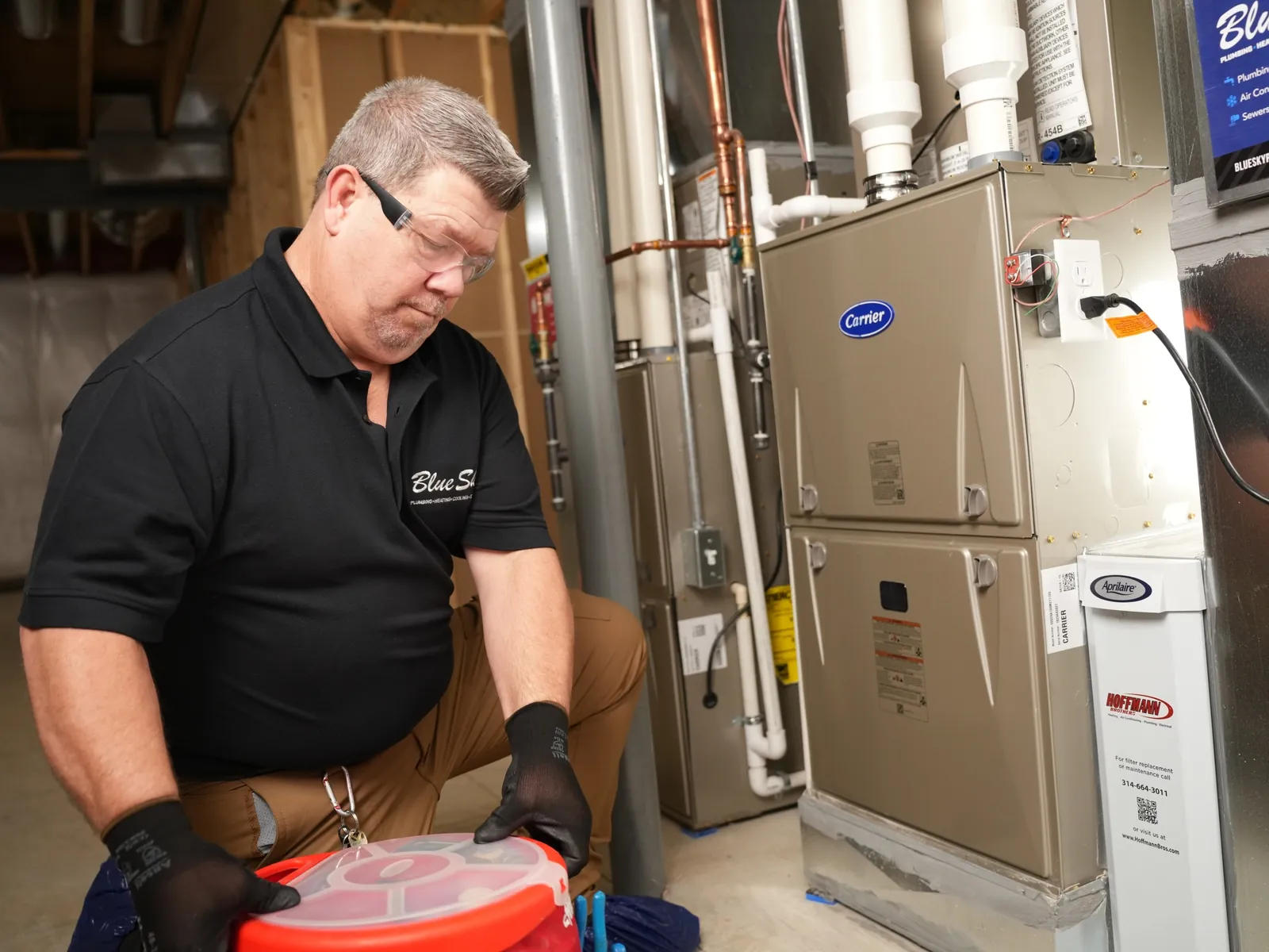 A plumber discussing a preventative maintenance plan with a commercial property manager in an office.